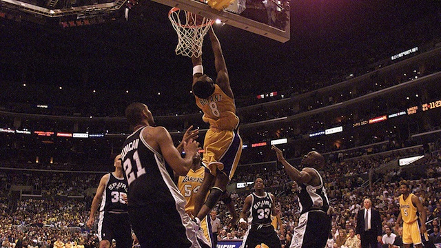 25 May 2001: Kobe Bryant #8 of the Los Angeles Lakers reverse dunks on the defense of the San Antonio Spurs during the fourth quarter of game three in the western conference finals at the Staples Center in Los Angeles, California. The Lakers beat the Spurs 111-72 and take a 3-0 lead in the best of 7 series. DIGITAL IMAGE. Mandatory Credit: Donald Miralle/ALLSPORT NOTE TO USER: It is expressly understood that the only rights Allsport are offering to license in this Photograph are one-time, non-exclusive editorial rights. No advertising or commercial uses of any kind may be made of Allsport photos. User acknowledges that it is aware that Allsport is an editorial sports agency and that NO RELEASES OF ANY TYPE ARE OBTAINED from the subjects contained in the photographs.